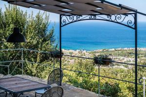 a patio with a table and chairs and the ocean at La Cantina - ACrapa Mangia in Santa Maria di Castellabate +8 photos