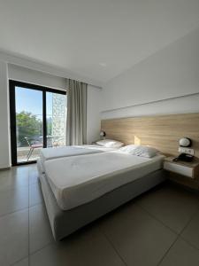 Posteľ alebo postele v izbe v ubytovaní Catherine Hotel