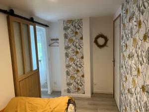 a bedroom with a wall with flowers on it at gite de saint lye in Saint-Lyé