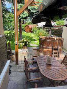 a patio with a table and chairs under an umbrella at Abigél Vendégház Keszthely in Keszthely