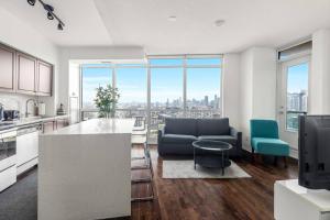 a kitchen and living room with a view of a city at 2 BR with Amazing city views & Free parking in Toronto