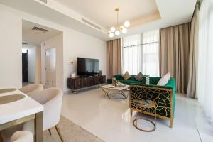 Dubai Marina的住宿－Key View - Calero Vista Villa，客厅配有绿色沙发和电视