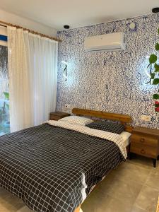 a bedroom with a bed with a black and white comforter at VİLLA DALAMAN in Dalaman