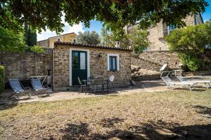 a patio with chairs and tables and a building at La Rimessa - ACrapa Mangia in Santa Maria di Castellabate