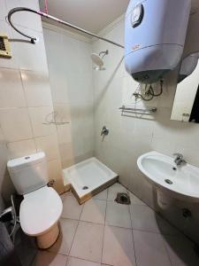 a bathroom with a toilet and a sink at Porto Sokhna Water Front Resort in Ain Sokhna