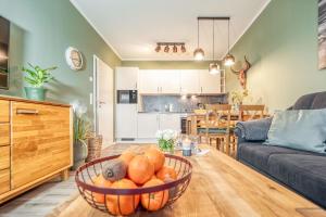 a living room with a bowl of fruit on a table at Strandstraße 16 - Wohnung 3 in Zingst