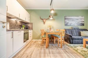 a kitchen and living room with a table and a couch at Strandstraße 16 - Wohnung 3 in Zingst