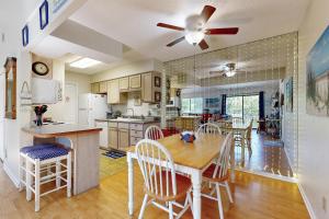 a kitchen and dining room with a table and chairs at Forest Ridge 2888 in Fernandina Beach