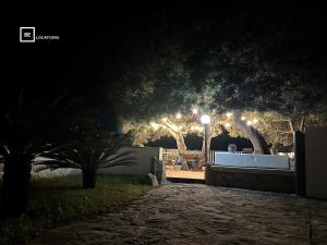um parque à noite com árvores e uma luz de rua em Le Terrazze di Solanas - BeLocations em Solanas