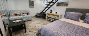 a bedroom with a bed and a ladder and a couch at Morii Lake Pool Villa in Bucharest