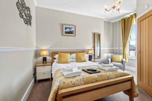 a bedroom with a bed with two towels on it at Beach Front Guest House in Eastbourne
