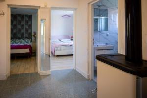 a room with a bedroom with a bed and a mirror at Apartman Milka in Slunj +28 photos