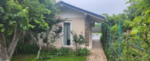 a small house with a brick fence in front of it at Morii Lake Pool Villa in Bucharest