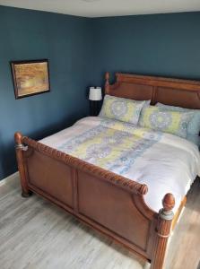 a bed with a wooden frame in a bedroom at Robin's Nest 2br At Duke Regional in Durham