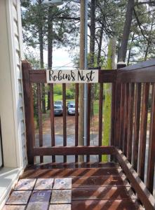 a wooden gate with a sign that reads returns nest at Robin's Nest 2br At Duke Regional in Durham