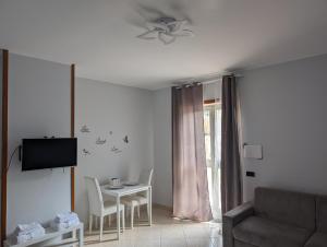 a living room with a couch and a table at NULA Private Suites in Pozzuoli