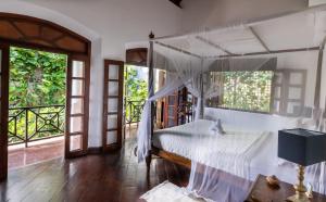 a bedroom with a bed with a canopy at Seven Pillars No 39 Galle Fort in Galle
