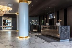 a lobby with a pillar and a reception desk at Radisson Collection Hotel, Tallinn in Tallinn