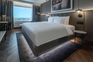 a hotel room with a large bed and a window at Radisson Collection Hotel, Tallinn in Tallinn