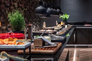 a kitchen with a buffet line with food at Radisson Collection Hotel, Tallinn in Tallinn