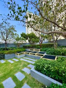 a garden with concrete steps and trees and a building at EDGE Cozy Vacation Condo infinite SKY Pool in Pattaya Central