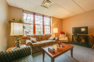 a living room with a couch and a table at New Kensington Vacation Rental with Shared Amenities in New Kensington