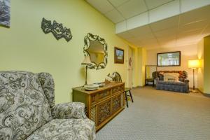 a living room with a chair and a mirror at New Kensington Vacation Rental with Shared Amenities in New Kensington