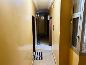 a hallway with a tile floor in a room at Studio in Dakar