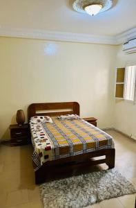 a bedroom with a bed in a room with a rug at Studio in Dakar