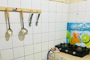 a kitchen with utensils hanging on a wall at Studio in Dakar