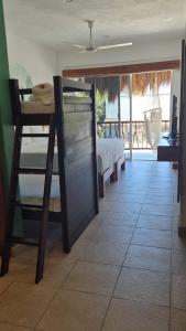 a bedroom with a bed and a view of a porch at Hotel Sonno Caliza Tulum in Tulum