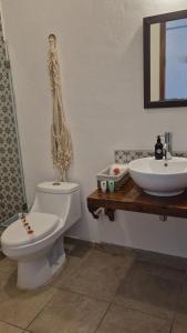 a bathroom with a toilet and a sink at Hotel Sonno Caliza Tulum in Tulum