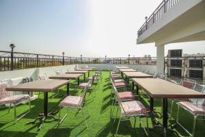 a row of tables and chairs on a roof at OYO Hotel Lotus Prime in Jaipur