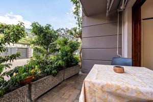 a table on the balcony of a house at Appartamenti Villa Adriana Torbole in Nago-Torbole