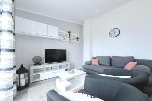 a living room with a couch and a tv at Simaruna in Maslenica