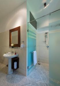 a bathroom with a sink and a glass shower at Seven Pillars No 39 Galle Fort in Galle