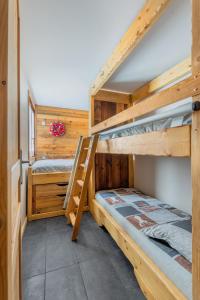 two bunk beds in a room with a staircase at Grand Chalet Standing Avec Jacuzzi à Chamrousse ski 1750 in Chamrousse