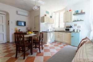 a kitchen with a table and chairs in a room at Casa Venturo in Minori