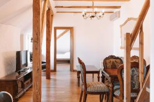 a living room with a dining room table and a television at DICTUMFACTUM Sky Apartment in Tallinn