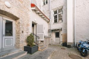 a motorcycle parked in front of a building at DICTUMFACTUM Sky Apartment in Tallinn