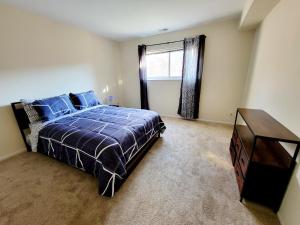 a bedroom with a bed and a dresser and a window at Cozy & Bright 1br Apartment In Elkins Park in Elkins Park