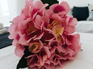 a bouquet of pink flowers sitting on a table at Nautilus City Studios & Apartments in Rhodes Town