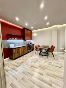 a kitchen and dining room with a table and chairs at Spiranca Apartments & Rooms in Tirana