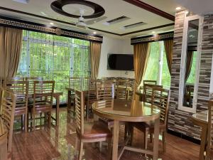 a conference room with tables and chairs and a tv at Areesh Hotel & Restaurant in Lower Topa