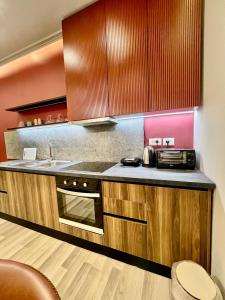 a kitchen with a sink and a stove top oven at Spiranca Apartments & Rooms in Tirana