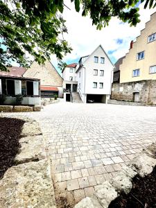 a brick driveway in front of some buildings at Hotel Wilma in Frickenhausen