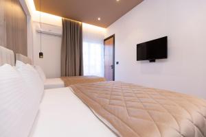 Postel nebo postele na pokoji v ubytování Hotel Joni