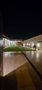 a large building with a courtyard at night at شاليه رفد in Ruwak