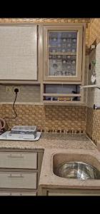 a kitchen with a sink and a counter top at شاليه رفد in Ruwak