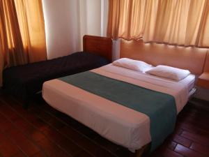 a hotel room with a bed and a window at HOTEL del OESTE B&B in Cali +21 photos